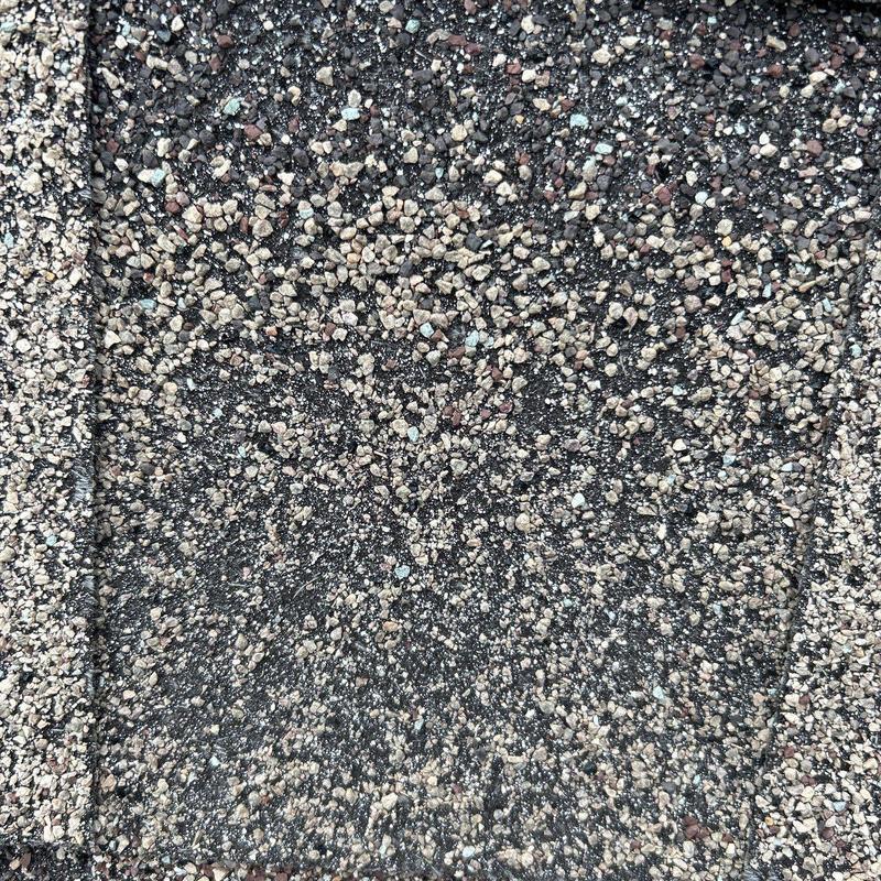 Roof shingles with hail impact damage close-up