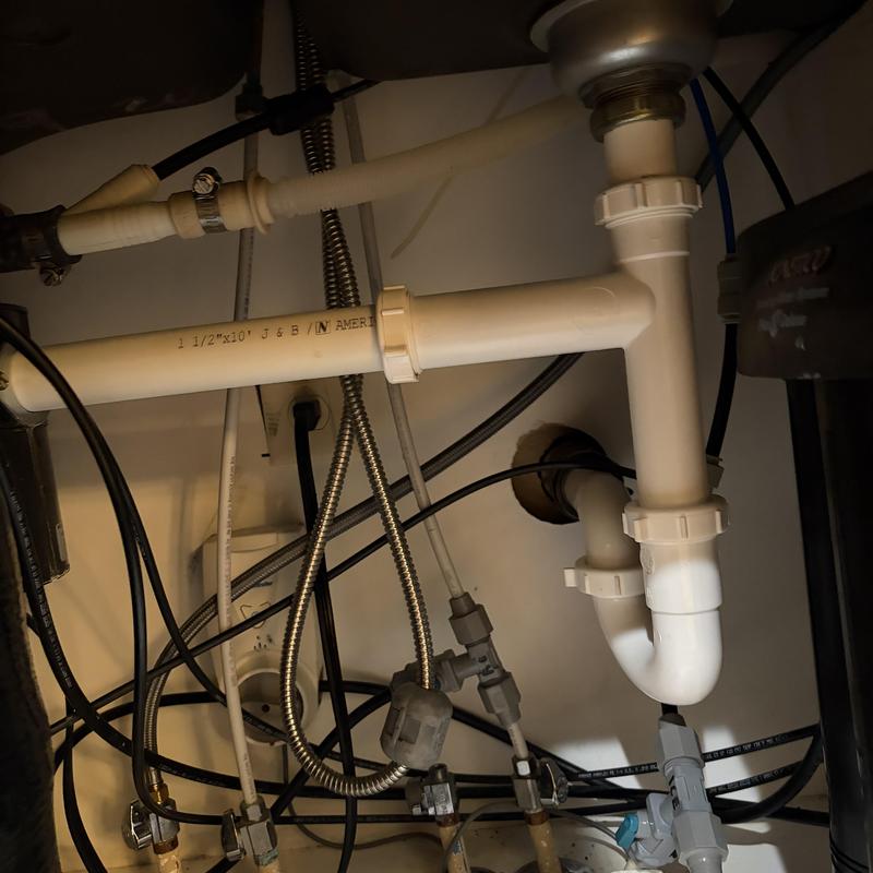 Kitchen sink drain pipes and water supply lines under cabinet Kitchen sink drain pipes and water supply lines under cabinet