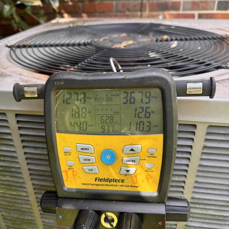 Heat pump pressure gauge on outdoor unit fan