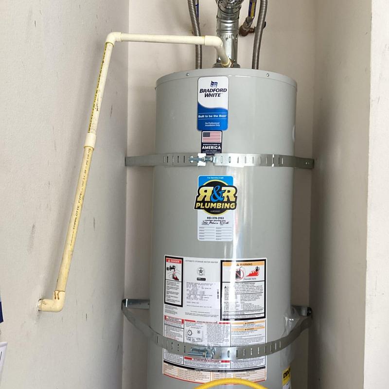 Water heater with plumbing installation in utility closet