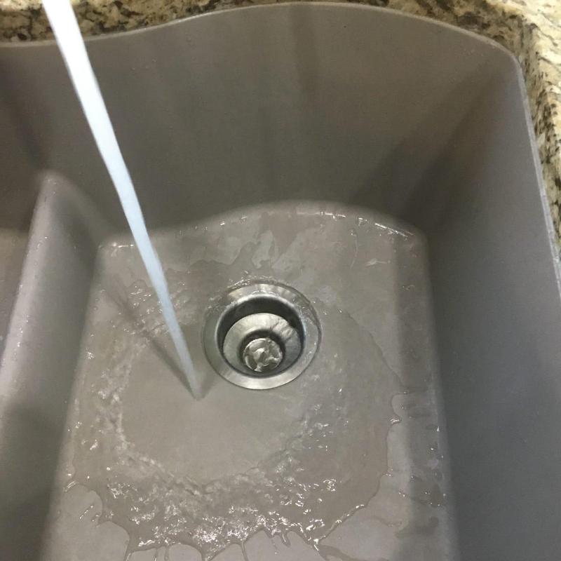Kitchen sink drain clearing with flowing water Kitchen sink drain clearing with flowing water