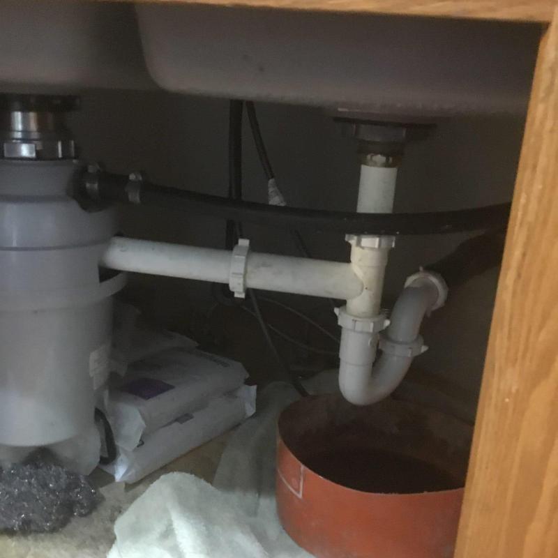 Kitchen sink drain pipes and P-trap assembly under cabinet Kitchen sink drain pipes and P-trap assembly under cabinet