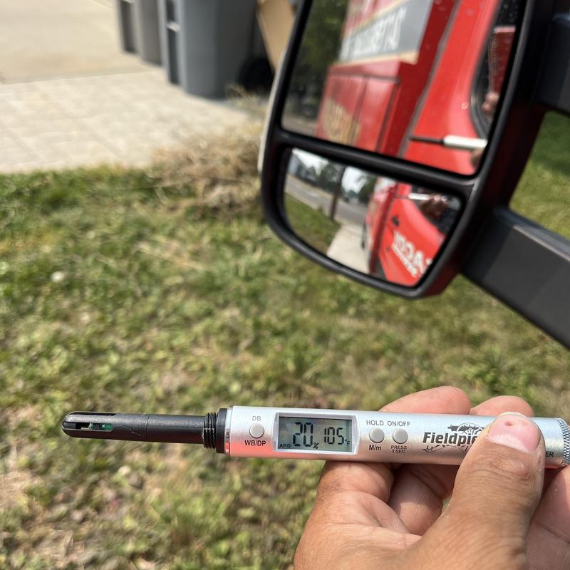 Humidity and temperature meter reading outdoors at AC job site Humidity and temperature meter reading outdoors at AC job site