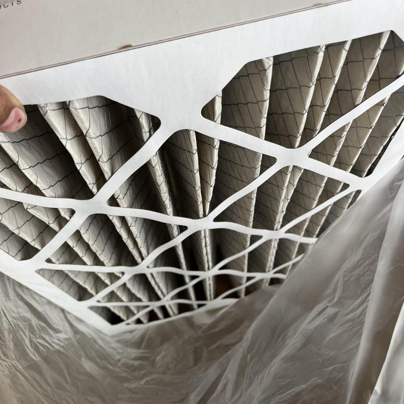 AC system pleated air filter being replaced AC system pleated air filter being replaced
