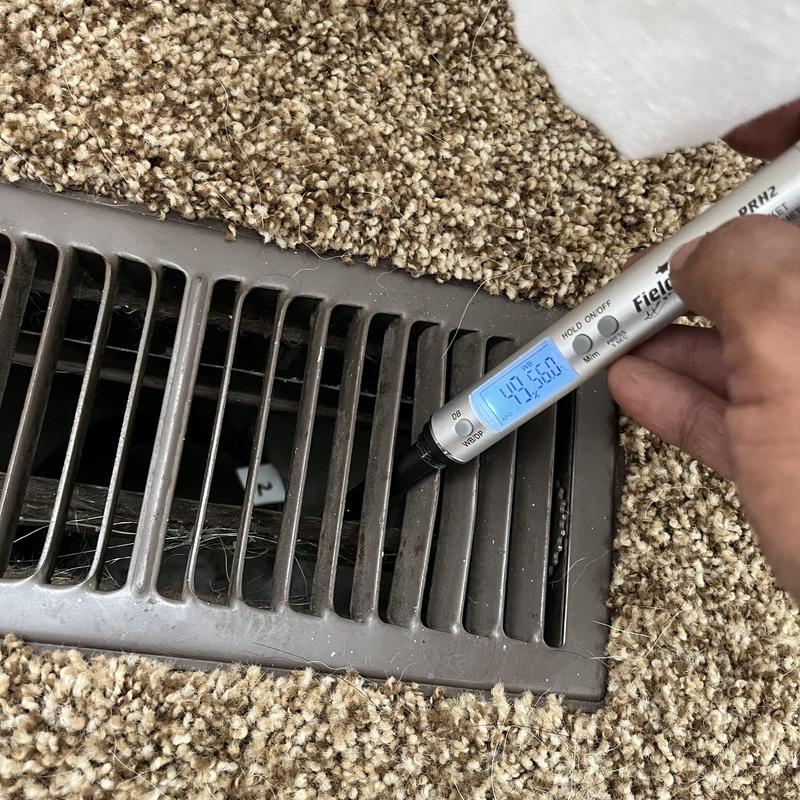 AC vent airflow testing with digital anemometer on carpet AC vent airflow testing with digital anemometer on carpet