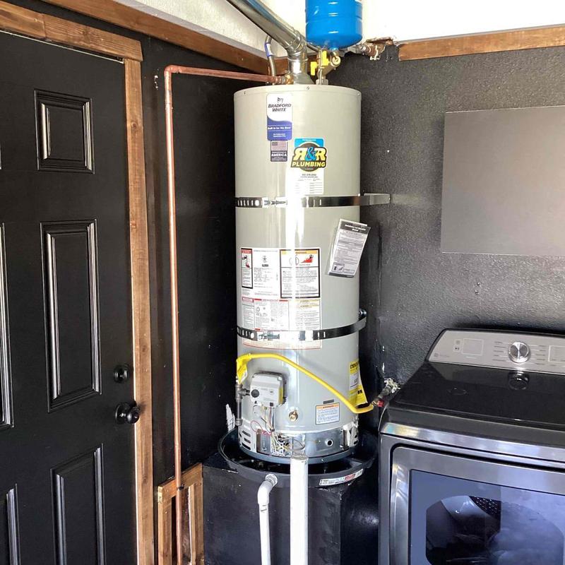 Water heater with gas line and sediment trap installation