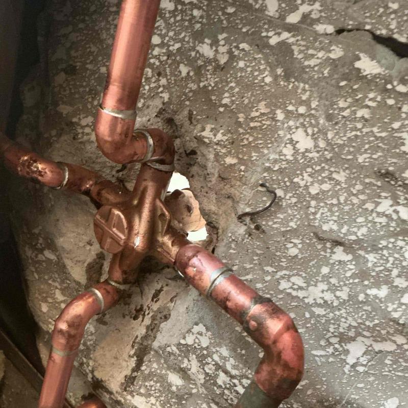Copper shower valve and plumbing behind drywall opening