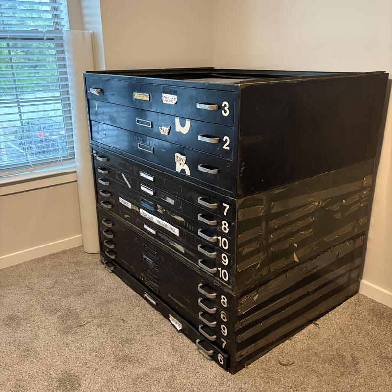 Flat file cabinet drawers stacked in apartment room