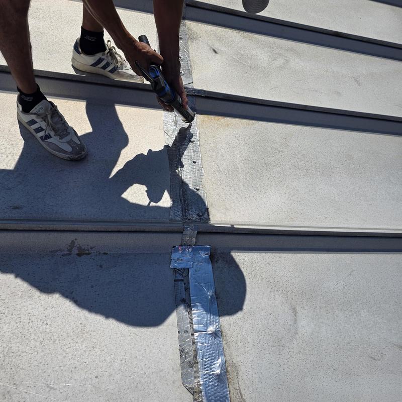 Metal roof seam with duct tape patch repair in Moore, SC