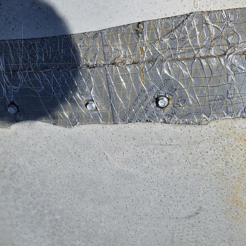 Metal roof panel with fasteners and wire mesh installed