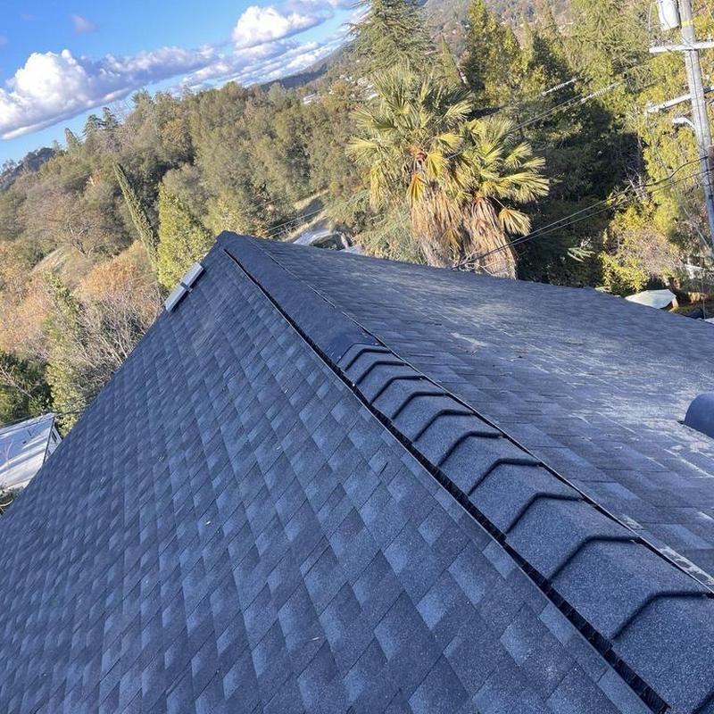 GAF asphalt shingle roof installation on home ridge