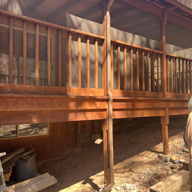 Wooden deck railing with vertical balusters outdoors