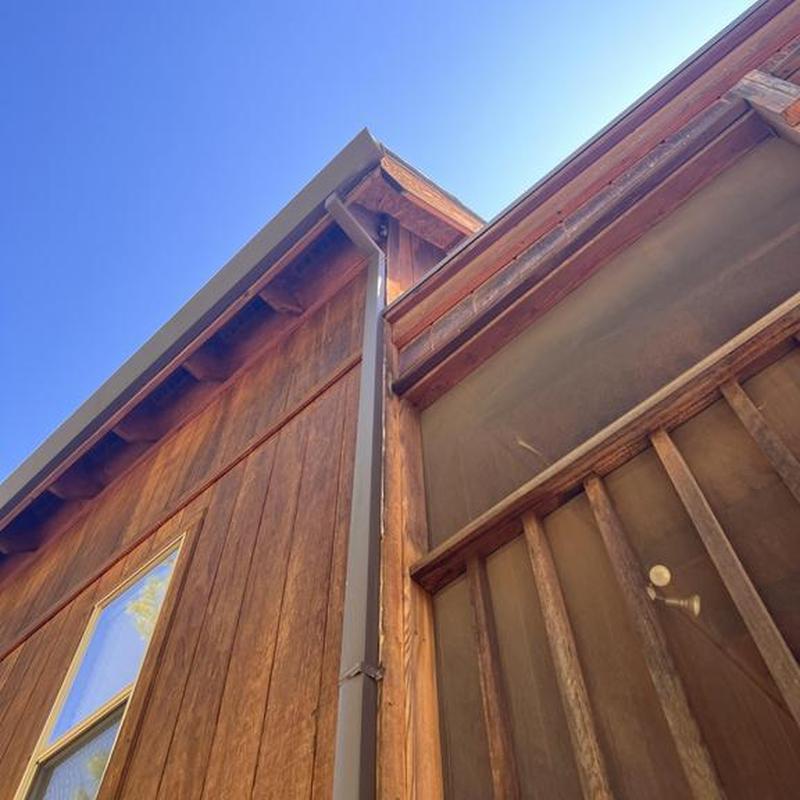 Seamless steel gutter with leaf guard on wooden house