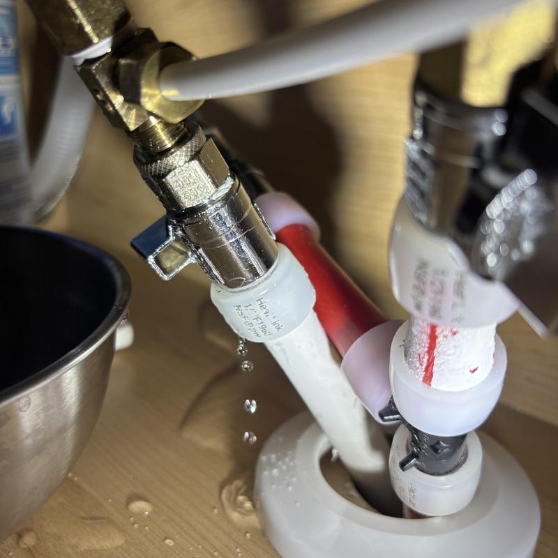 RO system fitting leak with dripping water drops RO system fitting leak with dripping water drops