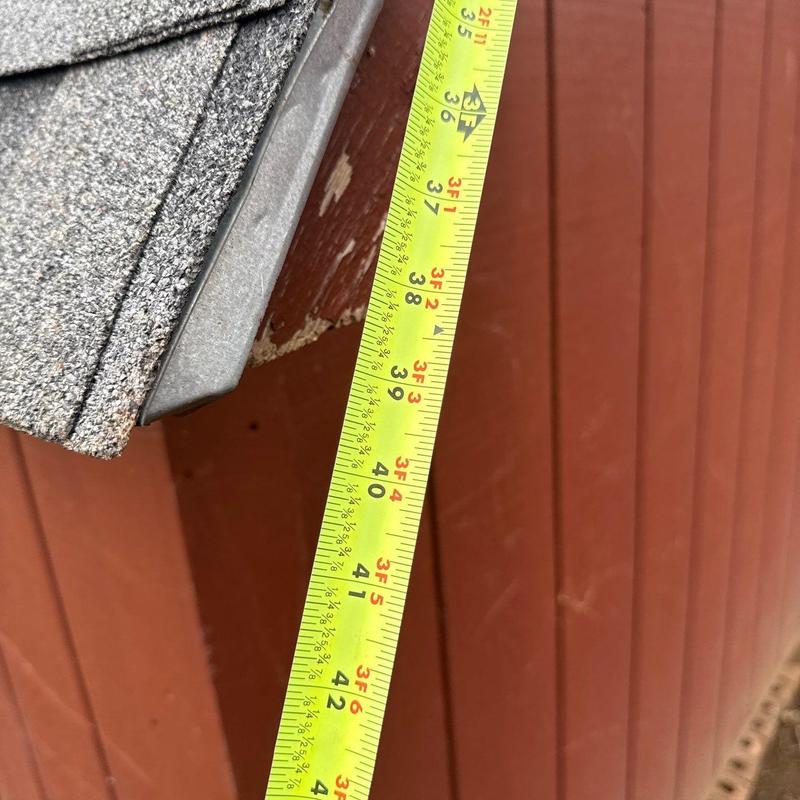 Roof edge and fascia damage with tape measure