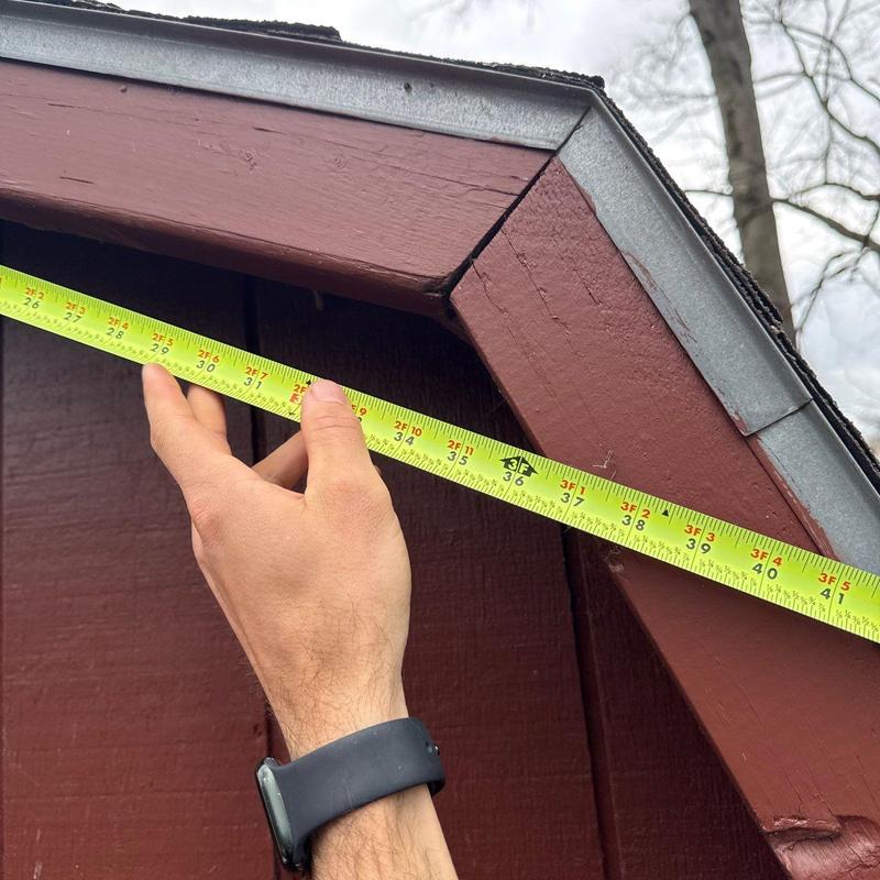 Roof fascia board measurement with tape measure