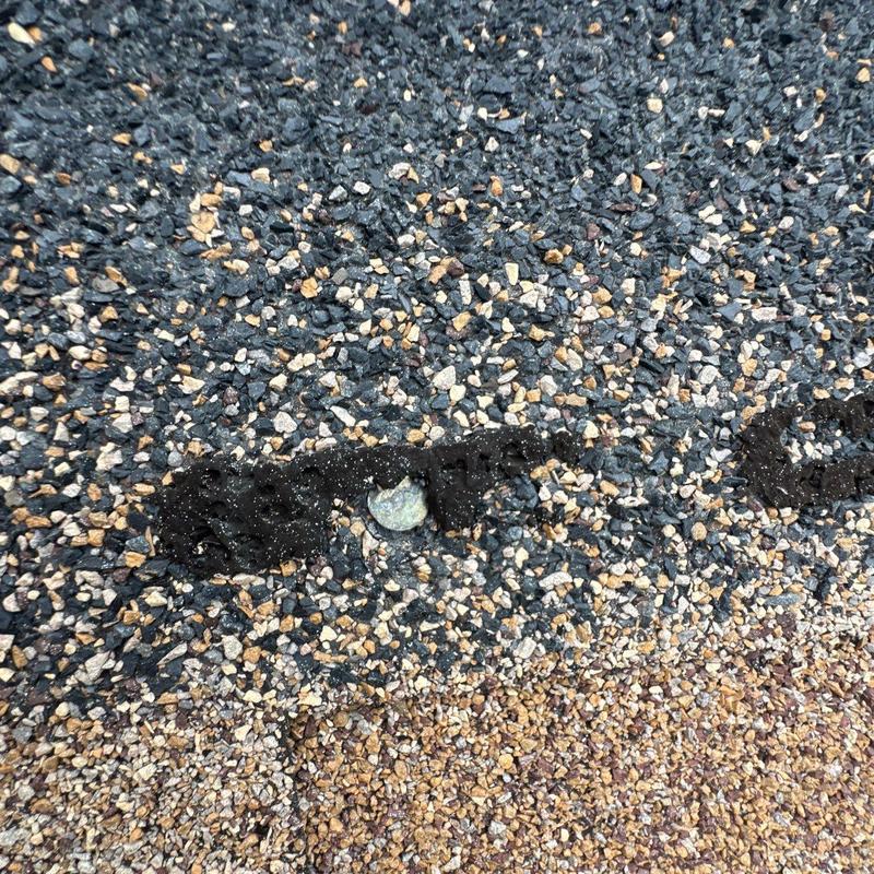 Asphalt shingle roof with hail impact damage close-up