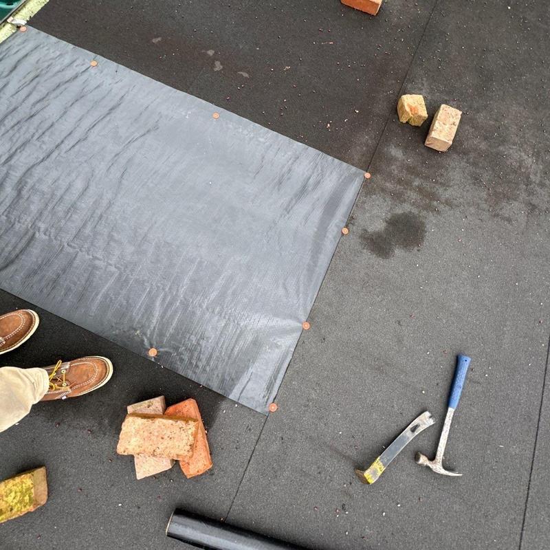 Roofing underlayment installation with bricks and tools