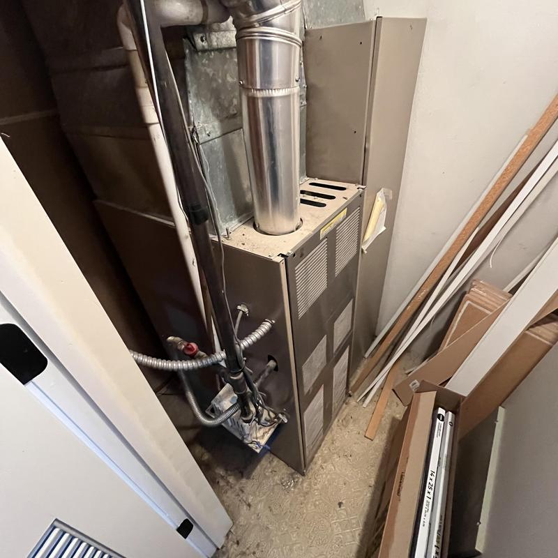 1980s gas furnace with vent pipe in utility closet 1980s gas furnace with vent pipe in utility closet