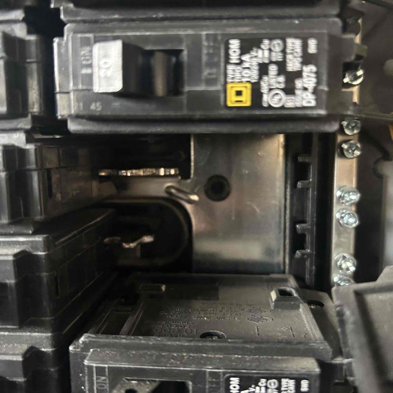 Electrical panel with tripped breakers removed for inspection Electrical panel with tripped breakers removed for inspection