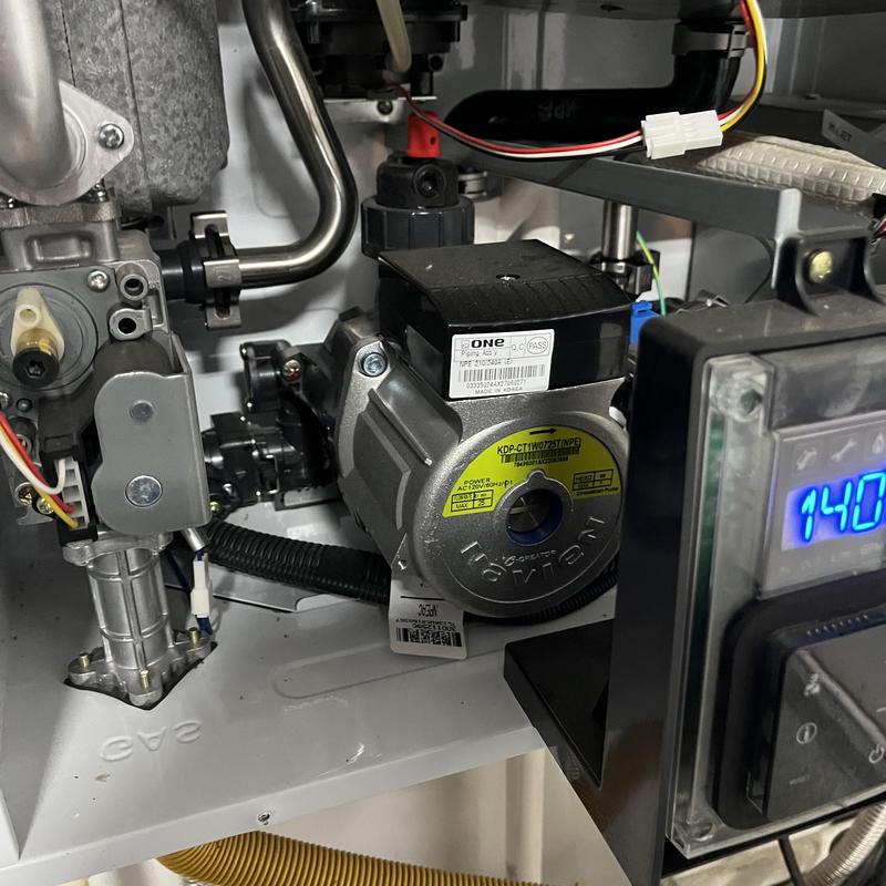 Tankless water heater internal pump and control panel Tankless water heater internal pump and control panel