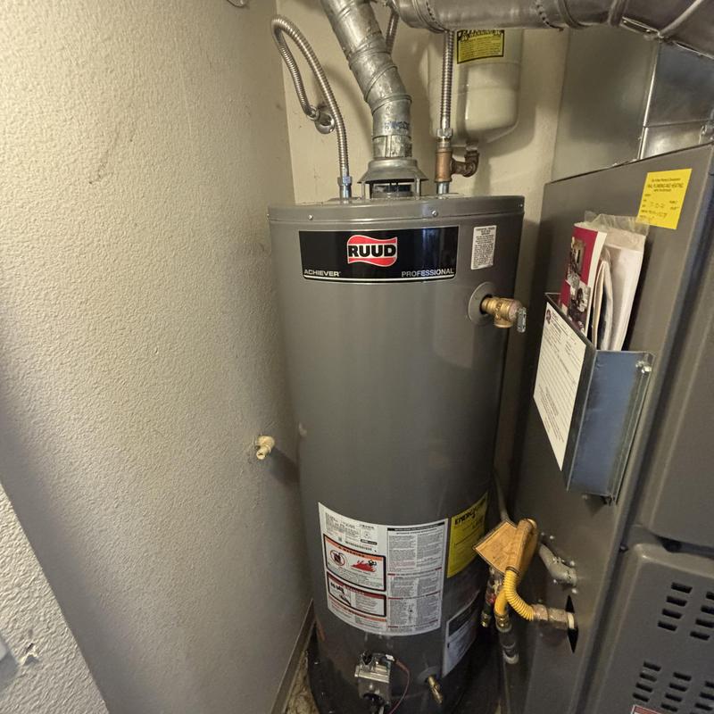 Water heater installation with venting and gas line connections Water heater installation with venting and gas line connections