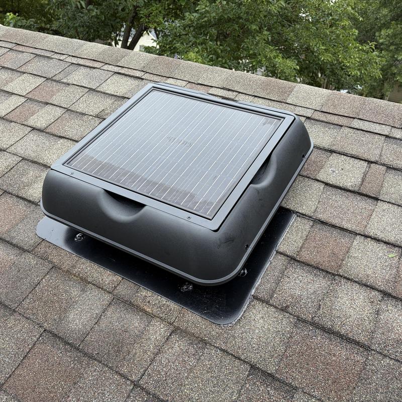 Solar-powered roof ventilation fan on shingle roof
