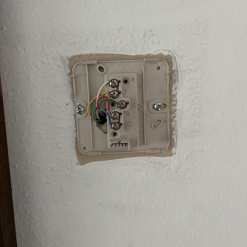 Thermostat wiring base installed in wall cavity Thermostat wiring base installed in wall cavity
