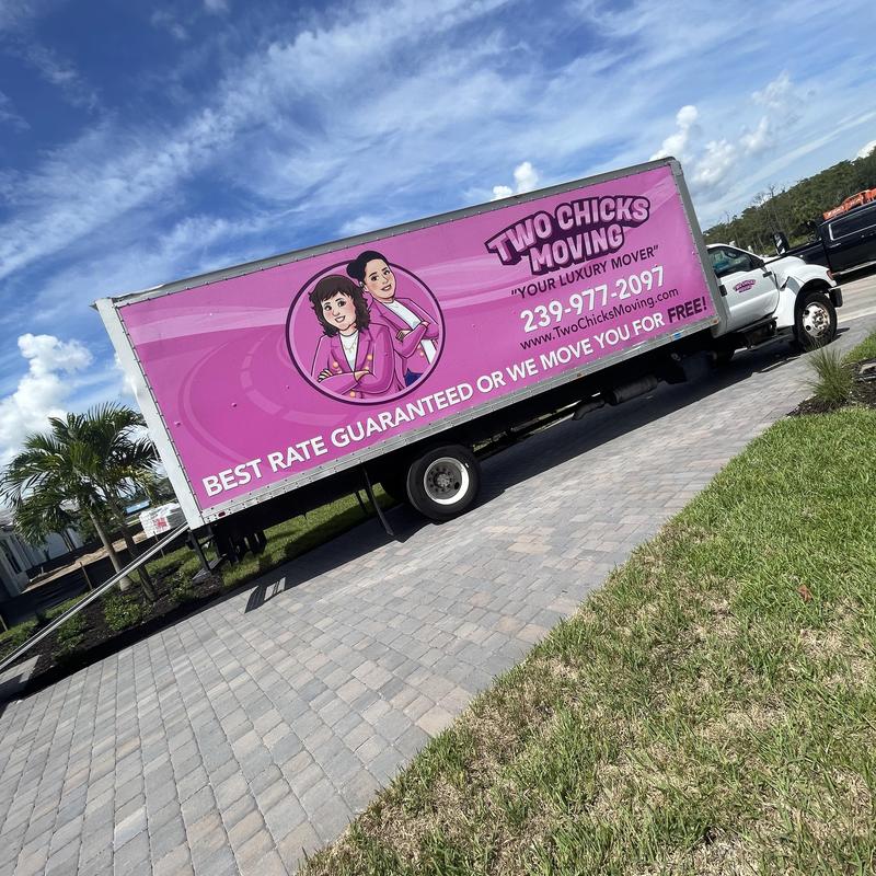 Moving truck with company branding parked on driveway Moving truck with company branding parked on driveway