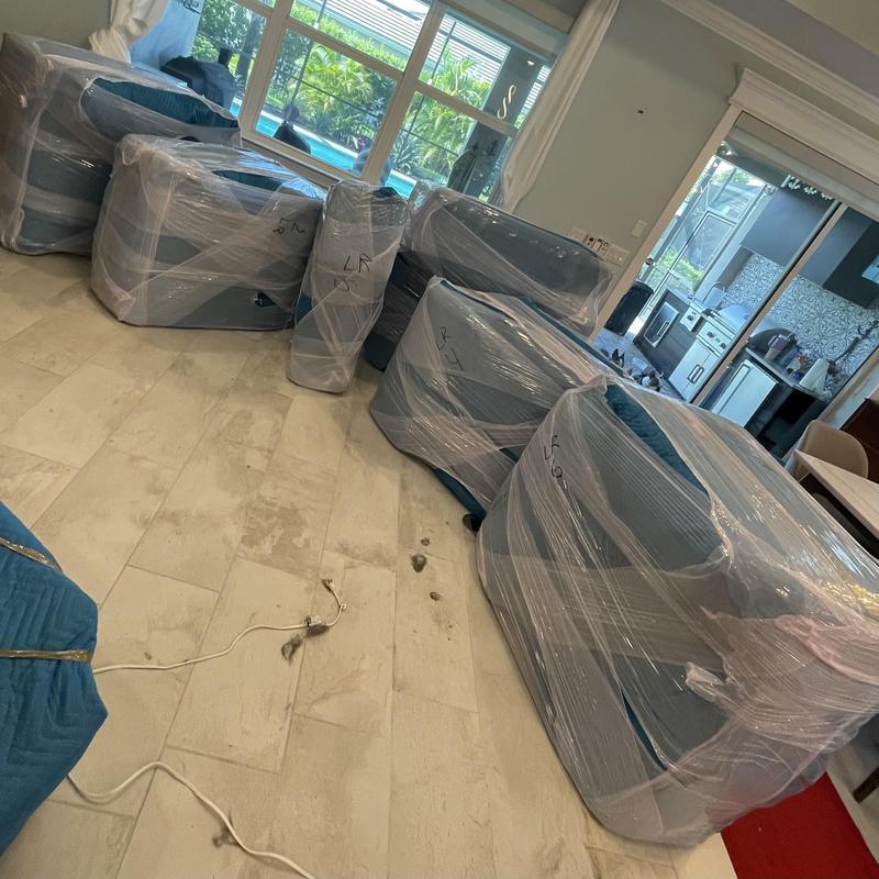 Furniture wrapped in plastic for moving protection Furniture wrapped in plastic for moving protection