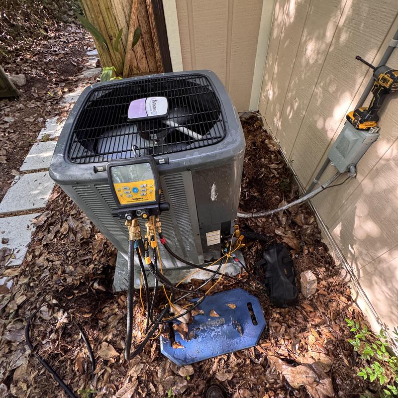Heat pump split system with diagnostic gauges outdoors