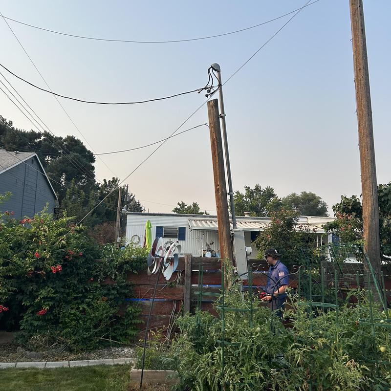 Power pole with in-ground junction box installation in backyard