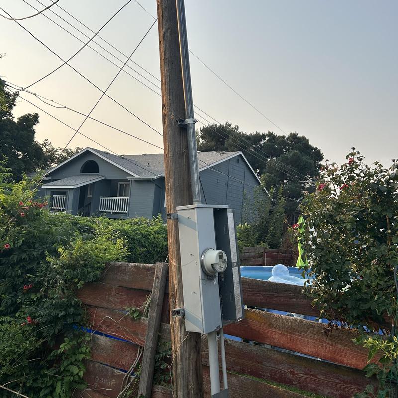 Power pole with electrical meter and junction box