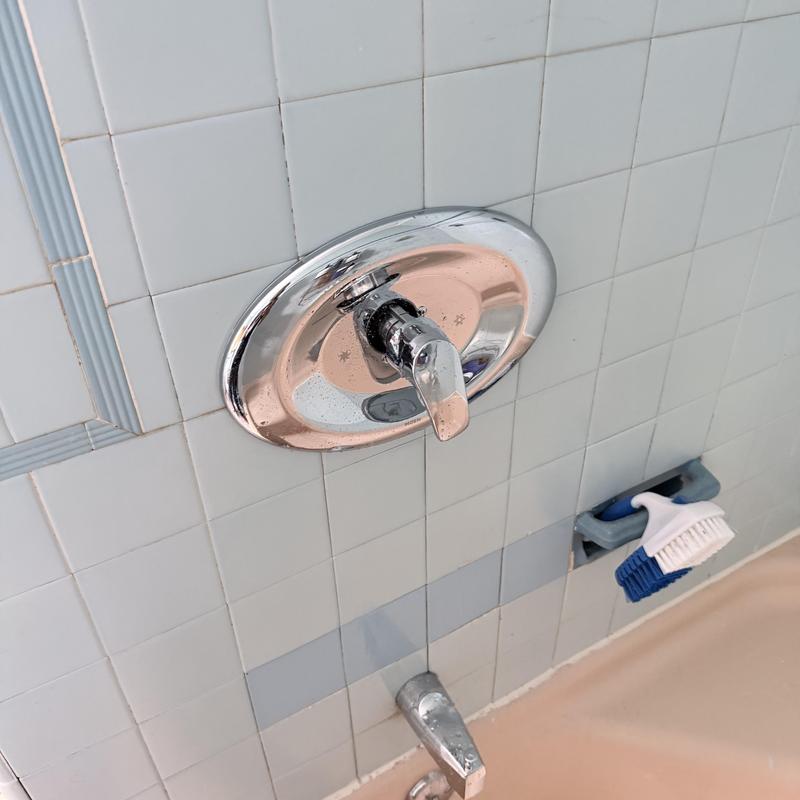Shower valve with chrome handle on tiled wall Shower valve with chrome handle on tiled wall
