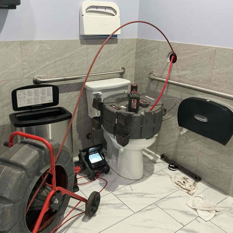 Mainline toilet drain with descaling and buildup removal tools