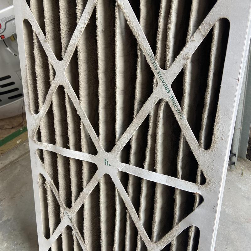 Air conditioner filter clogged with dust buildup Air conditioner filter clogged with dust buildup