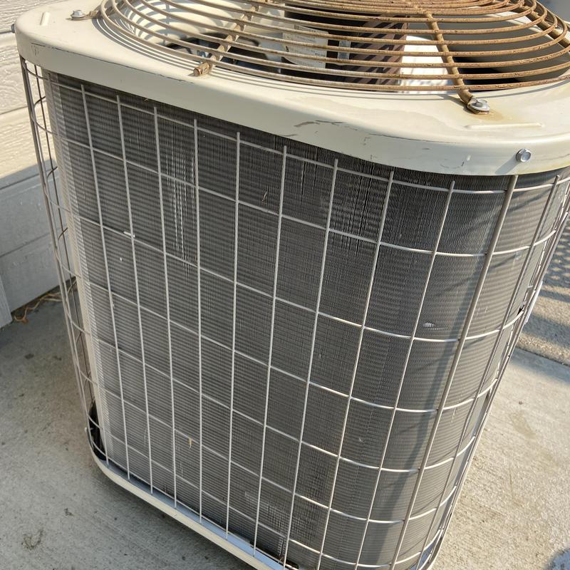 Outdoor air conditioner condenser unit with protective grille Outdoor air conditioner condenser unit with protective grille