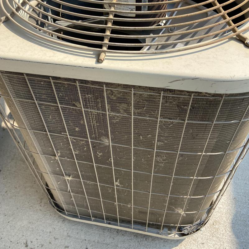 Outdoor air conditioner condenser with dirt buildup Outdoor air conditioner condenser with dirt buildup