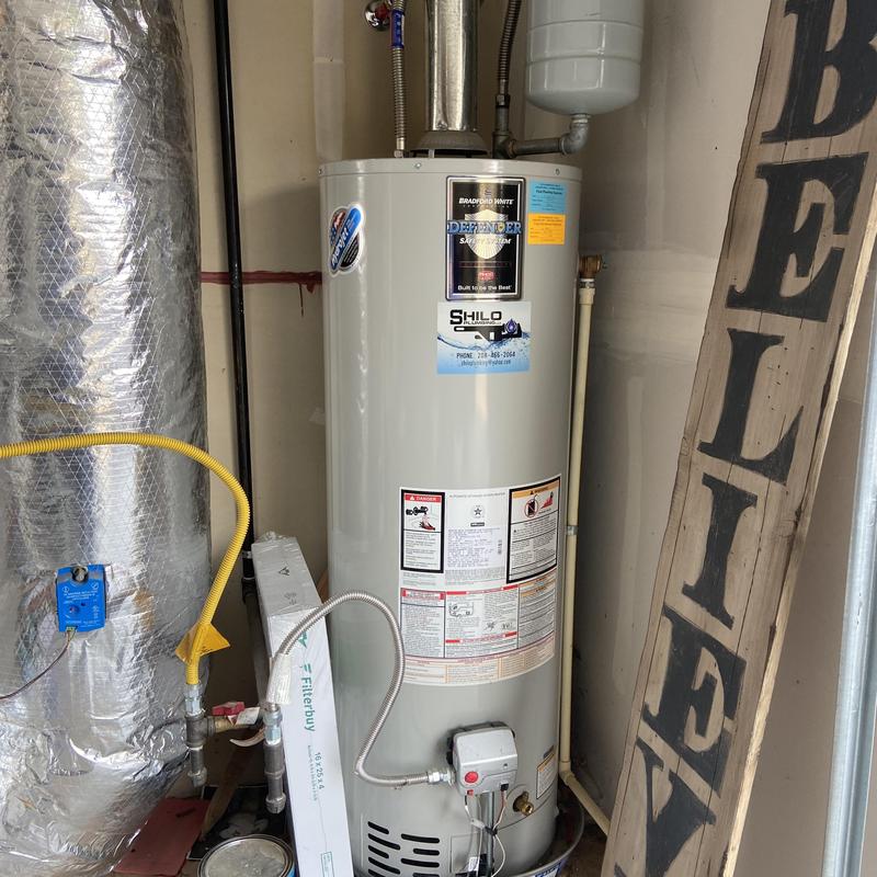 Water heater with pressure tank in residential garage Water heater with pressure tank in residential garage
