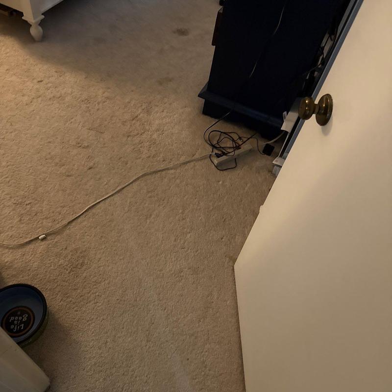 Carpet flooring with door and tangled cables