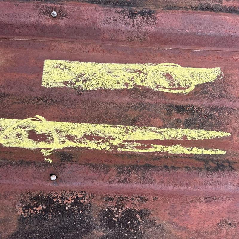 Metal roofing hail damage marked with yellow chalk