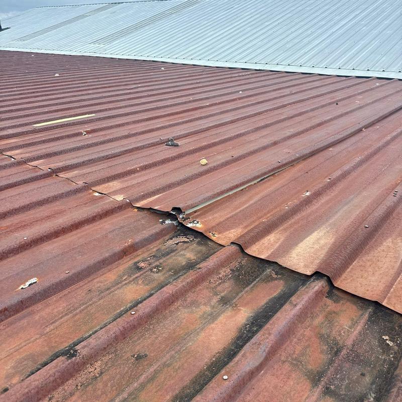 Metal roofing panels with rust and hail damage