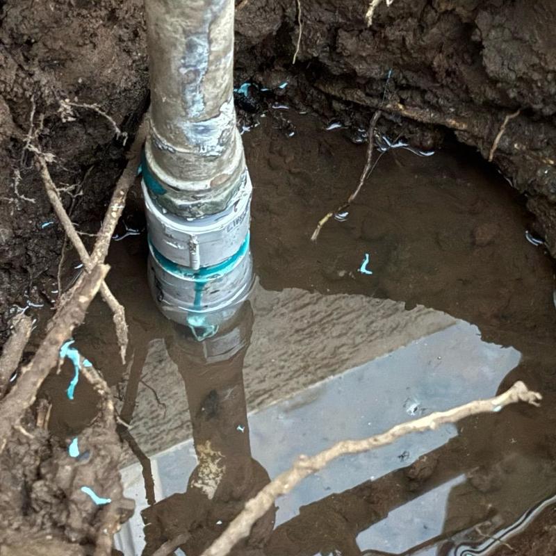 Underground water pipe leak with pooling water around it