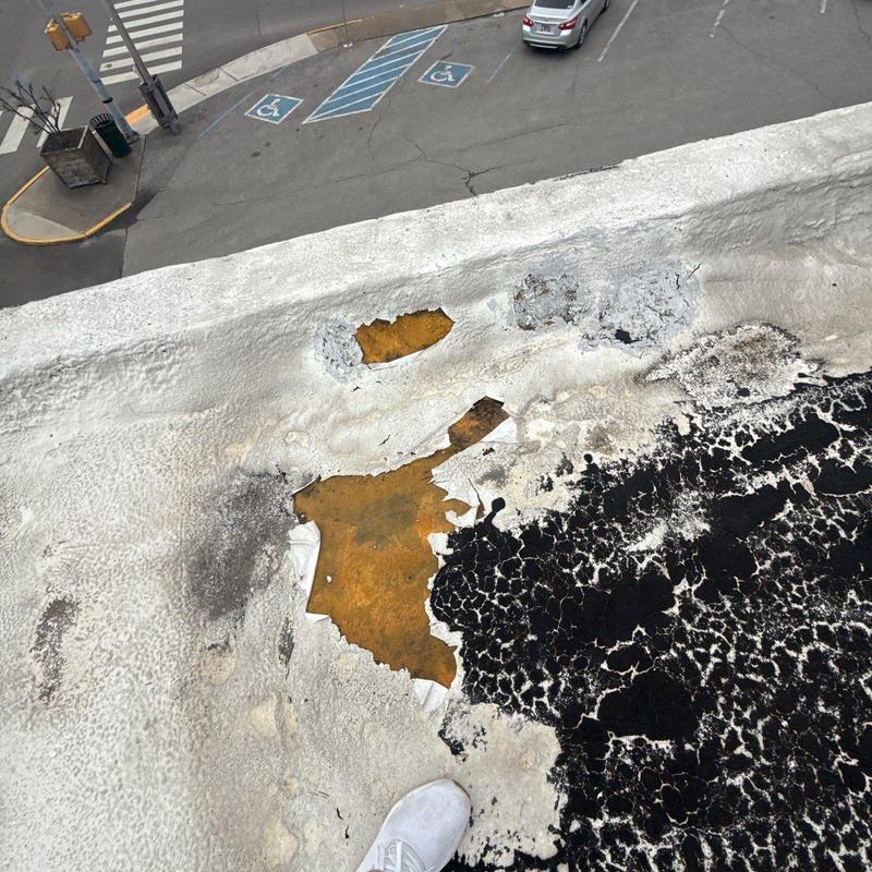 Commercial roof membrane damage with rust and wear