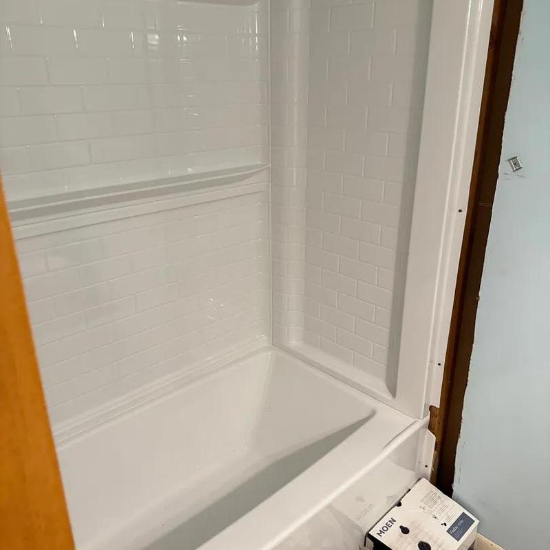 Tub shower combo with white tile surround installation Tub shower combo with white tile surround installation