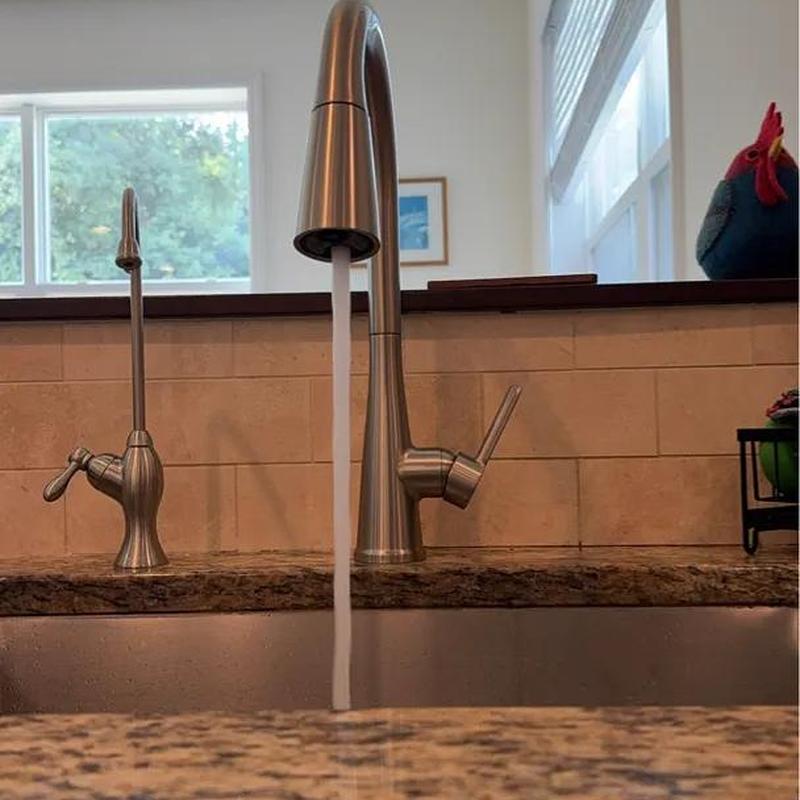 Kitchen faucet with running water in granite countertop Kitchen faucet with running water in granite countertop