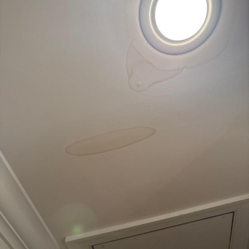 Ceiling water stains near circular light fixture