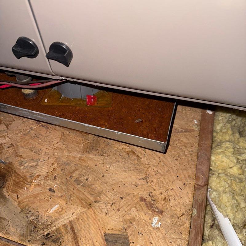 Furnace drip pan with rust and debris buildup