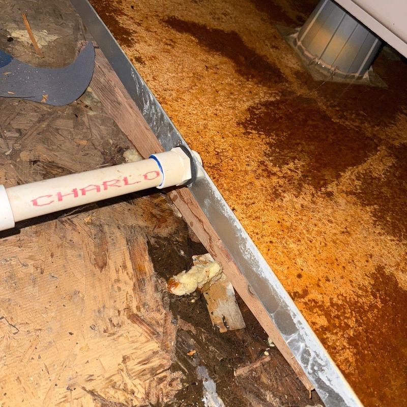 Rust-damaged metal roof flashing and wood decking