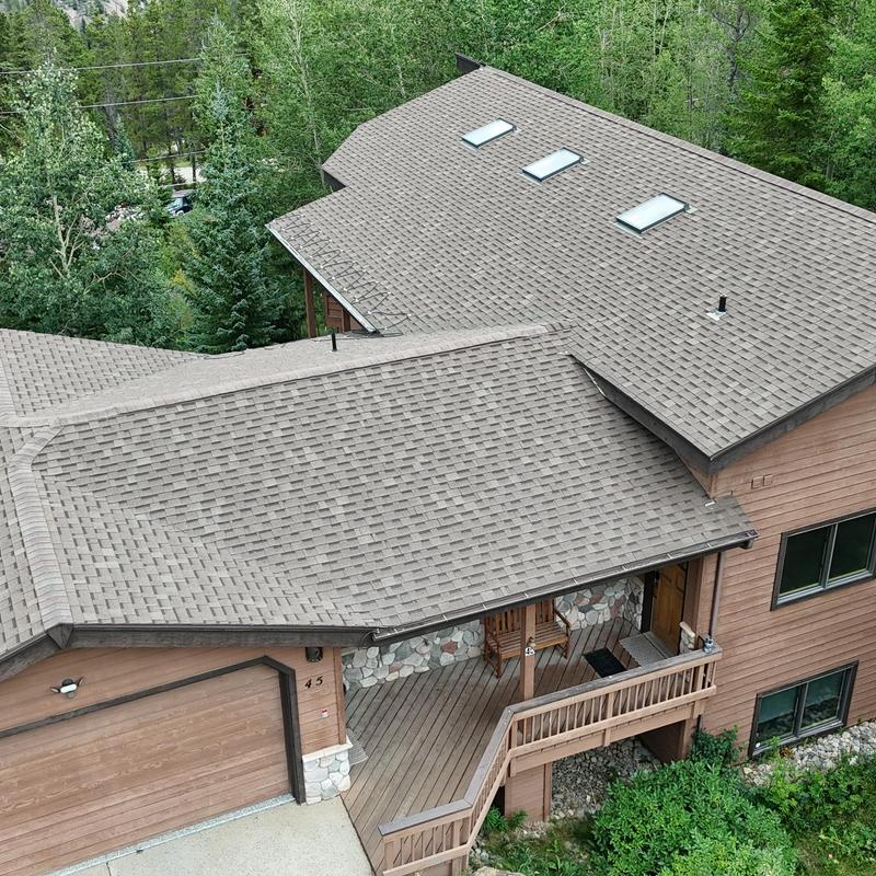 Asphalt shingle roof with skylights and ice guard system